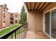 Condo balcony overlooking the grassy area and tree line on an overcast day at 4899 S Dudley St # 15B, Littleton, CO 80123