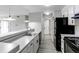 Modern kitchen features black appliances, white cabinets, sleek countertops, and stainless steel sink at 4899 S Dudley St # 15B, Littleton, CO 80123
