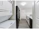 Well-organized kitchen near stacked washer/dryer with black appliances, and white cabinets at 4899 S Dudley St # 15B, Littleton, CO 80123