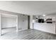 Living room adjacent to the kitchen provides an open layout with wood-look floors at 4899 S Dudley St # 15B, Littleton, CO 80123