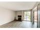 Bright living room features wood-look floors, fireplace and access to the balcony at 4899 S Dudley St # 15B, Littleton, CO 80123