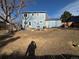 Large, unfinished backyard of the home with a fire pit and small deck at 4777 S Olathe St, Aurora, CO 80015