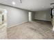 A spacious carpeted basement features freshly painted walls at 4777 S Olathe St, Aurora, CO 80015