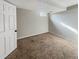 A large basement with tan carpet throughout and a small window at 4777 S Olathe St, Aurora, CO 80015