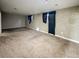 Spacious basement rec room with wall to wall carpeting features windows and neutral colored walls at 4777 S Olathe St, Aurora, CO 80015