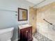 Updated bathroom with a tiled shower, mosaic floor, modern vanity, and grab bar at 4777 S Olathe St, Aurora, CO 80015