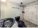 Updated bathroom with tile floors, a black toilet and sink, and a shower with marble tiles at 4777 S Olathe St, Aurora, CO 80015