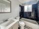 Full bathroom showcases black marble tiled walls and a sink with a chrome faucet at 4777 S Olathe St, Aurora, CO 80015