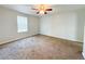 Bedroom with neutral walls, carpet flooring, and a window providing natural light at 4777 S Olathe St, Aurora, CO 80015