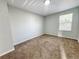 An empty bedroom filled with natural light features carpeting and a window with blinds at 4777 S Olathe St, Aurora, CO 80015