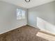 Bedroom with neutral carpeting, a window, and neutral walls bathed in natural light at 4777 S Olathe St, Aurora, CO 80015