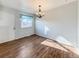 Dining area with hardwood floors, a decorative light fixture, and a large window at 4777 S Olathe St, Aurora, CO 80015