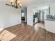 Bright dining room with hardwood floors and a view into the kitchen featuring stainless steel appliances at 4777 S Olathe St, Aurora, CO 80015