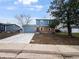 Split-level home with brick and blue siding, a concrete driveway, attached garage, and freshly laid lawn at 4777 S Olathe St, Aurora, CO 80015