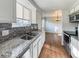 Kitchen with granite countertops, stainless steel appliances, and a view into the dining area at 4777 S Olathe St, Aurora, CO 80015