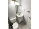 Bathroom with a toilet and a vanity, featuring gray tile floors at 1885 S Quebec Way # H27, Denver, CO 80231