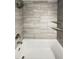 Bathroom featuring a bathtub and shower with neutral-toned tile surround at 1885 S Quebec Way # H27, Denver, CO 80231