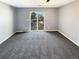 Carpeted bedroom with sliding glass doors to balcony with views at 1885 S Quebec Way # H27, Denver, CO 80231