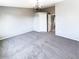Spacious bedroom features neutral colors, soft carpeting and a modern chandelier at 1885 S Quebec Way # H27, Denver, CO 80231