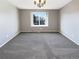 Empty dining room with neutral gray walls, carpeted floors and a hanging chandelier at 1885 S Quebec Way # H27, Denver, CO 80231