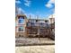 Exterior view of building featuring private deck with stairs and a combination of siding and brick facade at 1885 S Quebec Way # H27, Denver, CO 80231