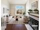 Bright living room with a large window, hardwood floors, fireplace, and modern furniture at 1885 S Quebec Way # H27, Denver, CO 80231