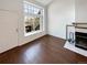 Bright living room featuring a fireplace, large window, and wood-look flooring at 1885 S Quebec Way # H27, Denver, CO 80231