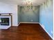 This open floor plan boasts a cozy fireplace and wood-look flooring at 1885 S Quebec Way # H27, Denver, CO 80231