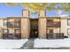 Front view of building showcasing landscaping and snowy walkway at 7820 W 87Th Dr # A, Arvada, CO 80005