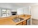 Modern kitchen featuring stainless steel appliances and light wood cabinets at 7820 W 87Th Dr # A, Arvada, CO 80005