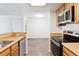 Modern kitchen with stainless steel appliances and wood cabinets at 7820 W 87Th Dr # A, Arvada, CO 80005