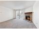 Living room with fireplace and sliding glass doors to balcony at 7820 W 87Th Dr # A, Arvada, CO 80005