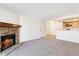 Living area with fireplace and view into kitchen area at 7820 W 87Th Dr # A, Arvada, CO 80005