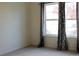 Empty bedroom featuring neutral carpet and a bright window with decorative curtains at 3220 Boulder Cir # 103, Broomfield, CO 80023