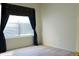 Bright bedroom with curtains and blind-covered window and neutral carpet at 3220 Boulder Cir # 103, Broomfield, CO 80023