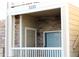 Inviting condo entrance featuring stone accents, wood siding and covered porch, creating a welcoming and secure entry at 3220 Boulder Cir # 103, Broomfield, CO 80023