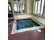 Indoor hot tub with a small handrail, set beneath windows, with a charming tile design in the water at 3220 Boulder Cir # 103, Broomfield, CO 80023