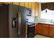 Well-lit kitchen features stainless steel appliances and natural wood cabinets and countertops at 3220 Boulder Cir # 103, Broomfield, CO 80023