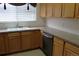 Charming kitchen featuring wood cabinetry, laminate countertops, and stainless steel appliances at 3220 Boulder Cir # 103, Broomfield, CO 80023