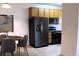Well-equipped kitchen showcasing modern black appliances and stylish wood cabinetry at 3220 Boulder Cir # 103, Broomfield, CO 80023