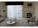 Bright living room featuring a fireplace, neutral tones, and large windows with outside views at 3220 Boulder Cir # 103, Broomfield, CO 80023