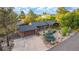 An elevated view reveals mature trees and an expansive driveway on a sunny day at 19 Rock Ln, Castle Rock, CO 80104