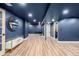 Finished basement with blue walls, hardwood floors, recessed lighting, and a mirror at 19 Rock Ln, Castle Rock, CO 80104