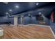 A spacious finished basement with blue walls, laminate flooring and a cozy fireplace at 19 Rock Ln, Castle Rock, CO 80104