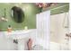 Unique bathroom featuring a pedestal sink, floral wallpaper, and patterned tile at 19 Rock Ln, Castle Rock, CO 80104