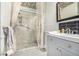 Cozy bathroom features decorative tile floor, glass enclosed shower with curtains and vanity with modern fixtures at 19 Rock Ln, Castle Rock, CO 80104