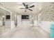 Bright bedroom with decorative wallpaper, a ceiling fan, a large closet, and a full-length mirror at 19 Rock Ln, Castle Rock, CO 80104
