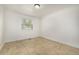 Bright bedroom featuring tile floors, white walls, decorative molding, and a window at 19 Rock Ln, Castle Rock, CO 80104