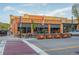 Charming brick cafe with outdoor seating, flowers, and American flags at 19 Rock Ln, Castle Rock, CO 80104
