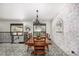 Dining room features a rustic table, chandelier, and a view to the outside through a wall of windows at 19 Rock Ln, Castle Rock, CO 80104